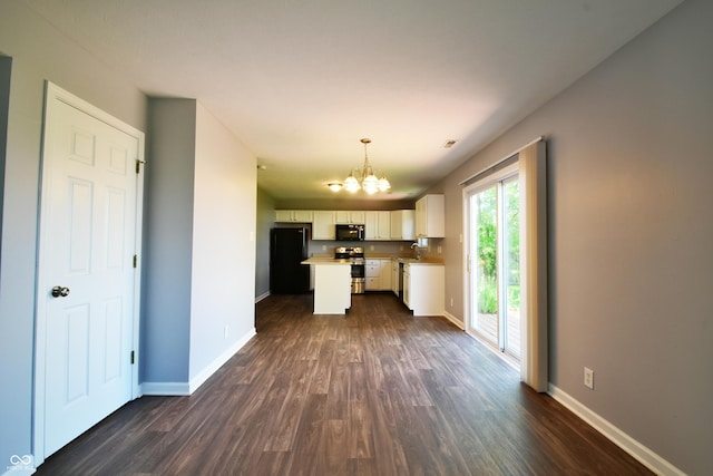 5262 Bogey Dr, Indianapolis, IN 46235 - kitchen with black appliances, a chandelier, dark wood finished floors, white cabinetry, and a kitchen island