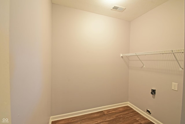 5262 Bogey Dr, Indianapolis, IN 46235 - laundry room featuring electric dryer hookup and dark wood-style flooring