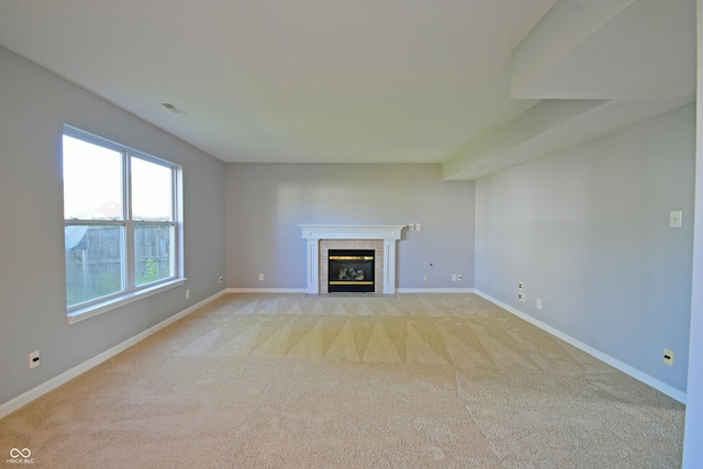 5262 Bogey Dr, Indianapolis, IN 46235 - unfurnished living room featuring light colored carpet and a tile fireplace