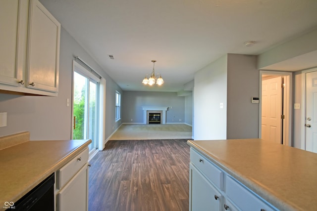 5262 Bogey Dr, Indianapolis, IN 46235 - kitchen featuring dark wood-style flooring, a chandelier, a glass covered fireplace, decorative light fixtures, and open floor plan