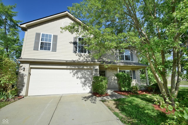 5262 Bogey Dr, Indianapolis, IN 46235 - view of front of home featuring driveway, a garage, brick siding, and a porch