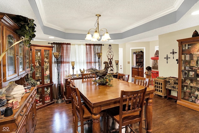17401 Austrian Pine Way, Westfield, IN 46074 - dining area with a raised ceiling, dark wood-type flooring, a chandelier, a textured ceiling, and crown molding