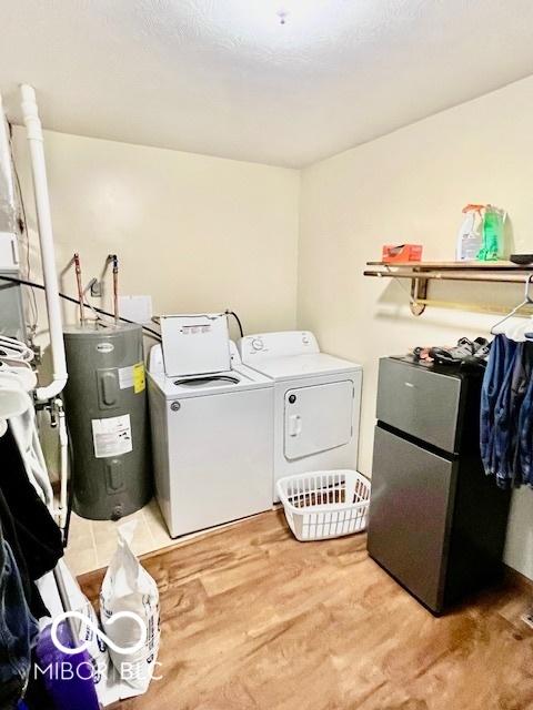409 N Kyle St, Edinburgh, IN 46124 - laundry room with electric water heater, washer and dryer, and light wood finished floors