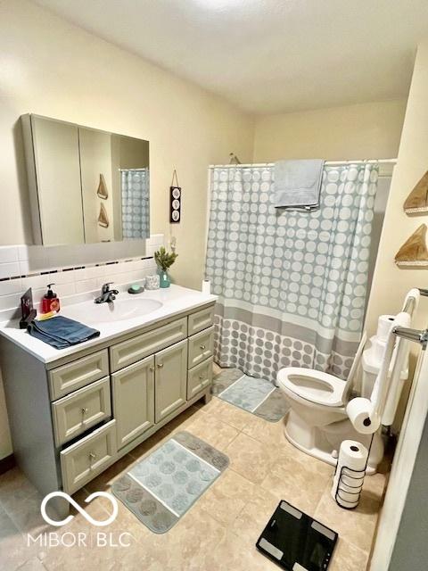 409 N Kyle St, Edinburgh, IN 46124 - bathroom with vanity, curtained shower, and tasteful backsplash