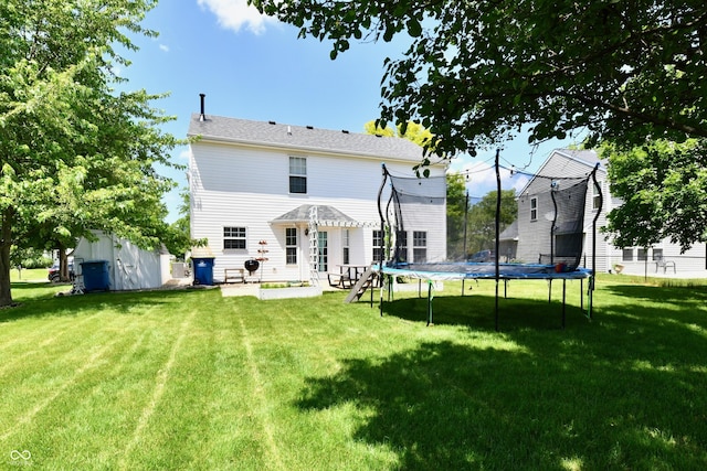 10539 Ross Xing, Fishers, IN 46038 - rear view of property featuring a trampoline, a lawn, a patio, and an outdoor structure