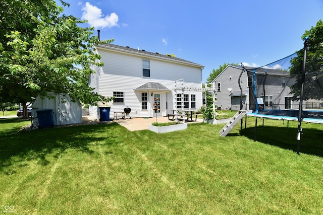 10539 Ross Xing, Fishers, IN 46038 - back of house with a trampoline, a patio area, and a lawn
