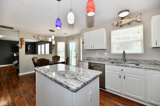 10539 Ross Xing, Fishers, IN 46038 - kitchen with stainless steel dishwasher, light stone counters, a center island, and white cabinetry