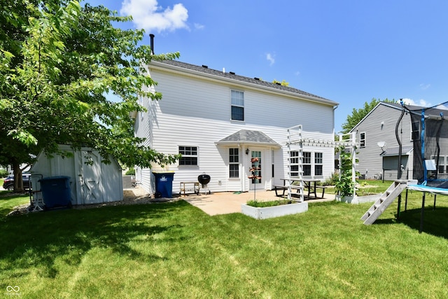10539 Ross Xing, Fishers, IN 46038 - rear view of property featuring a trampoline, a patio area, and a lawn