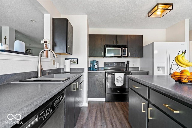 9497 W Stargazer Dr, Pendleton, IN 46064 - kitchen with appliances with stainless steel finishes, dark wood-style floors, dark countertops, and a textured ceiling