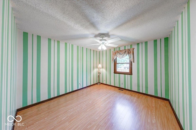 11 N Restin Rd, Greenwood, IN 46142 - spare room with light wood-type flooring, ceiling fan, and a textured ceiling