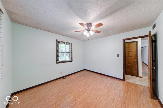 11 N Restin Rd, Greenwood, IN 46142 - empty room featuring light wood-style floors, a ceiling fan, and a textured ceiling