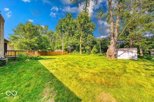11 N Restin Rd, Greenwood, IN 46142 - view of green lawn featuring a storage unit and a deck