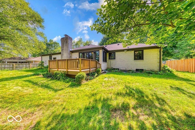 11 N Restin Rd, Greenwood, IN 46142 - back of house with a deck, a fenced backyard, brick siding, and a chimney