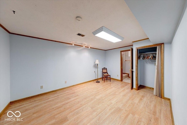 11 N Restin Rd, Greenwood, IN 46142 - unfurnished bedroom with wood finished floors, ornamental molding, a closet, and a textured ceiling