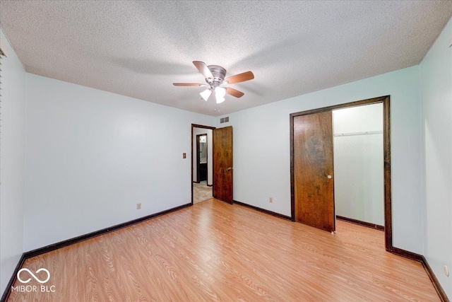 11 N Restin Rd, Greenwood, IN 46142 - unfurnished bedroom featuring light wood finished floors, a closet, a textured ceiling, and a ceiling fan