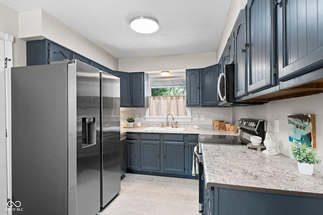 121 Hooton Blvd, Madison, IN 47250 - kitchen featuring stainless steel appliances, light countertops, blue cabinets, and light tile patterned flooring