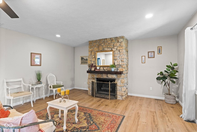 121 Hooton Blvd, Madison, IN 47250 - living area with wood finished floors, a stone fireplace, recessed lighting, and ceiling fan