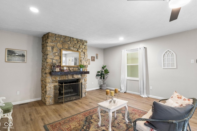 121 Hooton Blvd, Madison, IN 47250 - living room with wood finished floors, ceiling fan, a fireplace, recessed lighting, and a textured ceiling