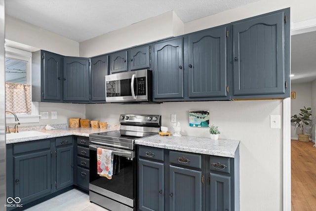 121 Hooton Blvd, Madison, IN 47250 - kitchen featuring stainless steel appliances, light countertops, and light wood-style floors
