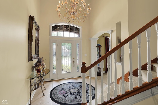 4704 Pearcrest Way, Greenwood, IN 46143 - tiled foyer entrance with a high ceiling, arched walkways, a chandelier, and stairs