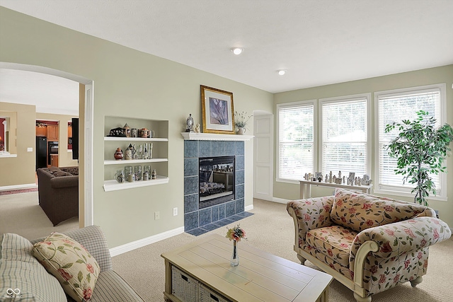 4704 Pearcrest Way, Greenwood, IN 46143 - living room with carpet flooring, arched walkways, and a tiled fireplace