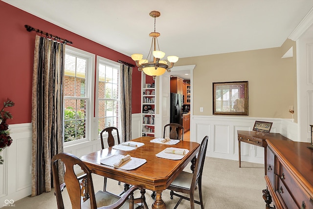 4704 Pearcrest Way, Greenwood, IN 46143 - dining area featuring wainscoting, a decorative wall, a chandelier, and light carpet