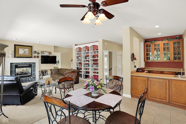 4704 Pearcrest Way, Greenwood, IN 46143 - dining space featuring a ceiling fan, light tile patterned floors, a tiled fireplace, and recessed lighting