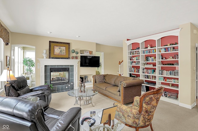 4704 Pearcrest Way, Greenwood, IN 46143 - carpeted living room featuring a tiled fireplace and arched walkways
