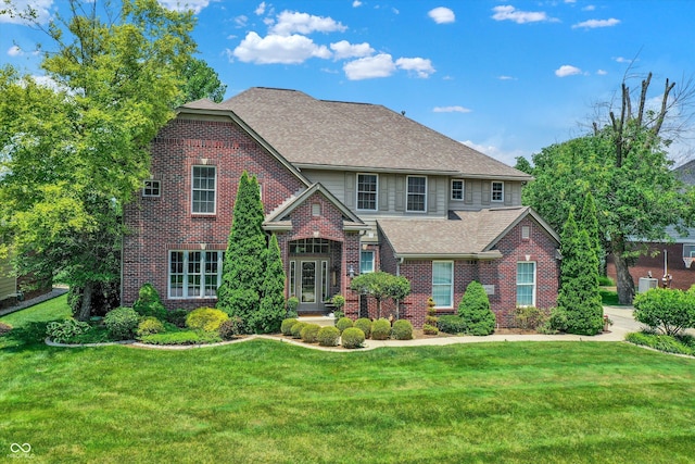 4704 Pearcrest Way, Greenwood, IN 46143 - traditional-style house featuring brick siding, a front lawn, and roof with shingles