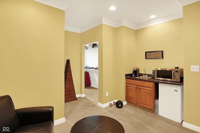 4704 Pearcrest Way, Greenwood, IN 46143 - kitchen featuring stainless steel microwave, light colored carpet, crown molding, refrigerator, and brown cabinetry