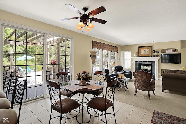 4704 Pearcrest Way, Greenwood, IN 46143 - dining space with light tile patterned floors, a tile fireplace, a ceiling fan, and light colored carpet