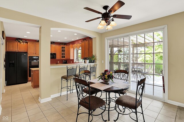 4704 Pearcrest Way, Greenwood, IN 46143 - dining area featuring light tile patterned floors, ceiling fan, arched walkways, and recessed lighting