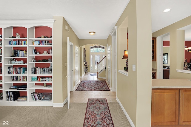 4704 Pearcrest Way, Greenwood, IN 46143 - foyer with light tile patterned floors, arched walkways, light carpet, and recessed lighting