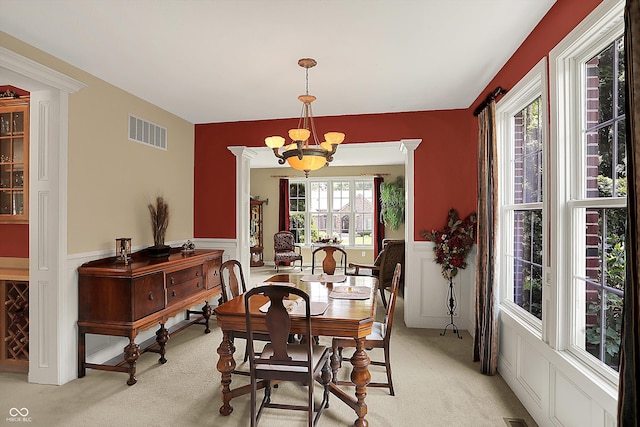 4704 Pearcrest Way, Greenwood, IN 46143 - dining room with a chandelier, light carpet, and wainscoting