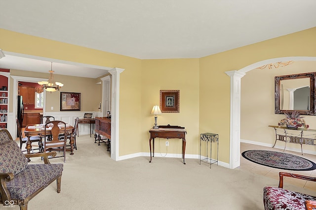 4704 Pearcrest Way, Greenwood, IN 46143 - living room with decorative columns, a chandelier, light carpet, and arched walkways