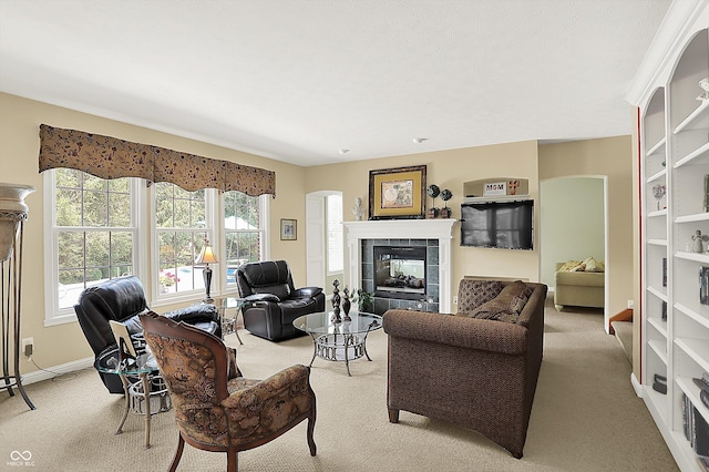 4704 Pearcrest Way, Greenwood, IN 46143 - living area with light carpet, a fireplace, and arched walkways