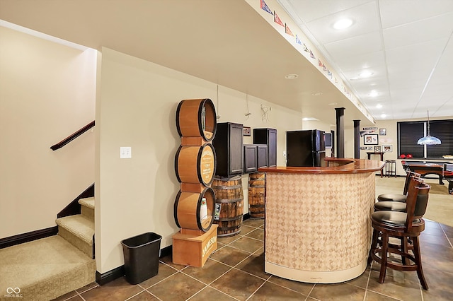 4704 Pearcrest Way, Greenwood, IN 46143 - bar with freestanding refrigerator, dark tile patterned floors, recessed lighting, stairway, and decorative light fixtures