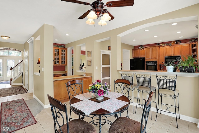 4704 Pearcrest Way, Greenwood, IN 46143 - dining area featuring light tile patterned floors, ceiling fan, arched walkways, and recessed lighting
