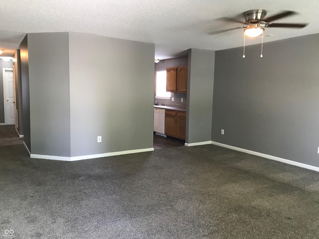 3929 Roundwood Dr, Indianapolis, IN 46235 - unfurnished living room with a ceiling fan, dark colored carpet, and a textured ceiling