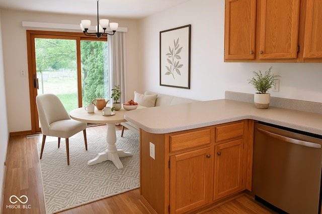 3363 Paddington Dr, Columbus, IN 47203 - kitchen featuring stainless steel dishwasher, light countertops, a chandelier, light wood-type flooring, and a peninsula