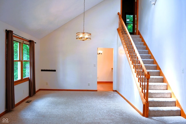 3363 Paddington Dr, Columbus, IN 47203 - stairs with high vaulted ceiling, carpet floors, and a chandelier