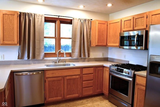 3363 Paddington Dr, Columbus, IN 47203 - kitchen featuring appliances with stainless steel finishes, light countertops, recessed lighting, and brown cabinets