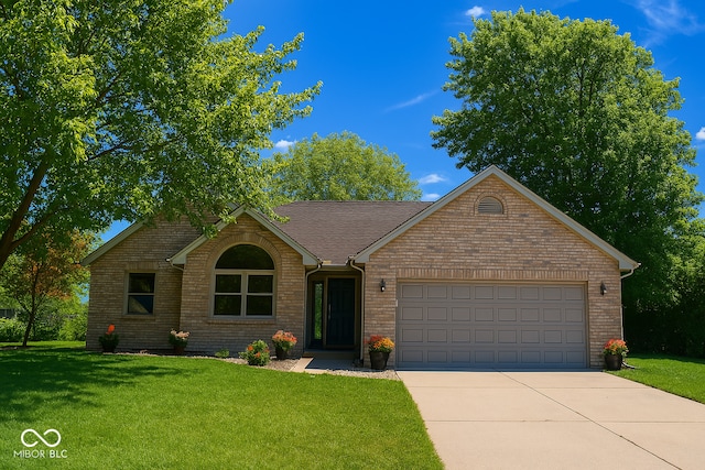 3363 Paddington Dr, Columbus, IN 47203 - view of front of home with a garage, driveway, and a front lawn