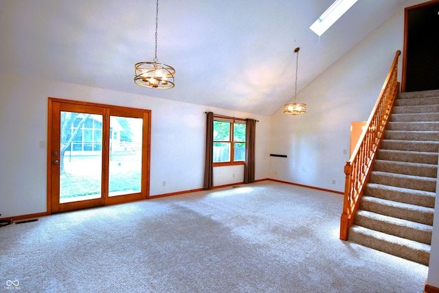 3363 Paddington Dr, Columbus, IN 47203 - unfurnished living room with a chandelier, stairs, carpet floors, high vaulted ceiling, and a skylight