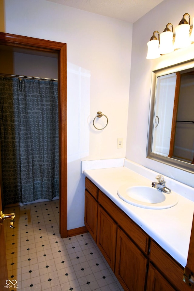 3363 Paddington Dr, Columbus, IN 47203 - full bath with vanity, tile patterned floors, and curtained shower