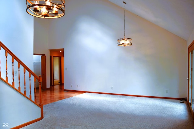 3363 Paddington Dr, Columbus, IN 47203 - unfurnished living room featuring high vaulted ceiling, carpet floors, a chandelier, and stairway