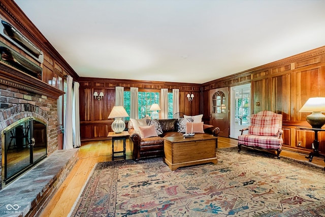 6280 N Chester Ave, Indianapolis, IN 46220 - living area with crown molding, wood finished floors, wooden walls, and a brick fireplace