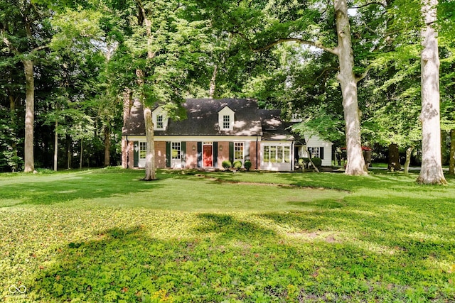 6280 N Chester Ave, Indianapolis, IN 46220 - cape cod home featuring a front lawn and brick siding