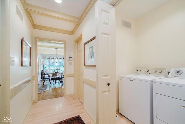 6280 N Chester Ave, Indianapolis, IN 46220 - laundry area featuring independent washer and dryer, light wood-style flooring, and a chandelier