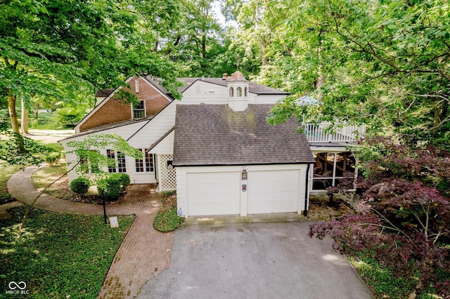 6280 N Chester Ave, Indianapolis, IN 46220 - view of front facade with a shingled roof, asphalt driveway, and an attached garage